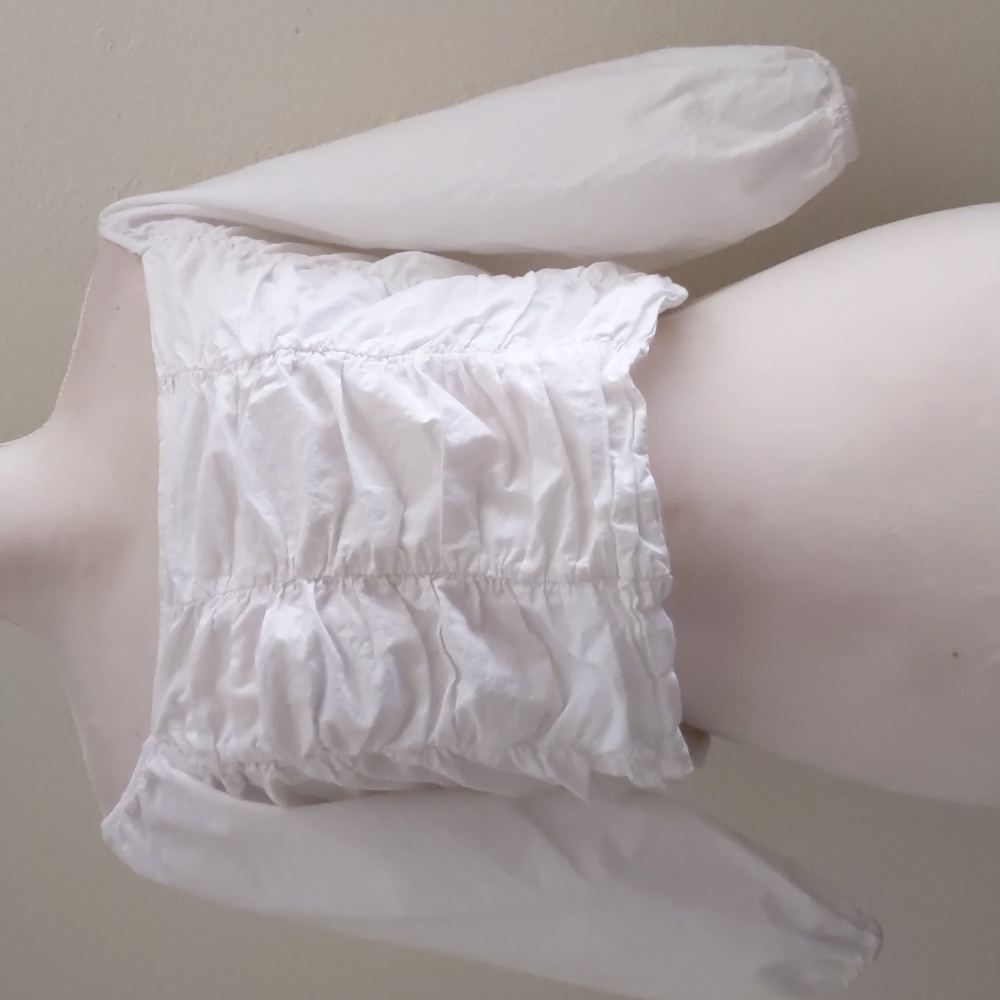 It's pink, white ruched top with elastic in back, puffy sleeves crop top size L